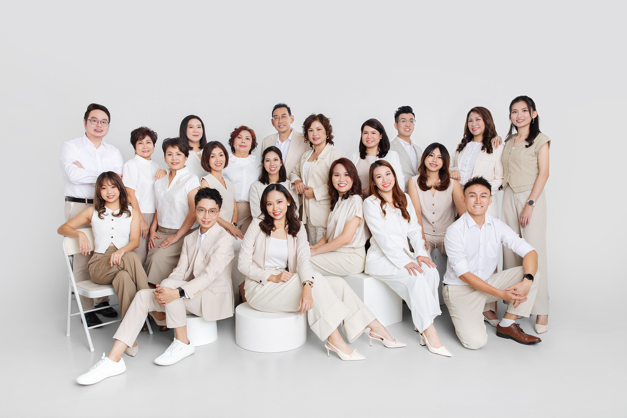 Corporate team portrait of professional women in neutral outfits photographed in a minimalist studio in Selango
