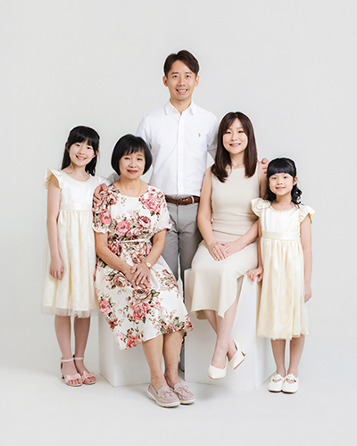 Family portrait of a mother and her family in a natural studio setting in Selangor